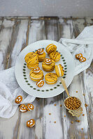 Caramel macarons decorated with pretzels