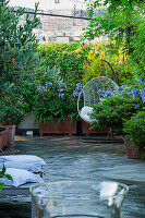 Raised flower beds and hanging chairs on the terrace