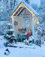 Arbour decorated for Christmas in snow-covered garden