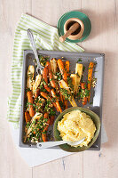 Oven roasted sausages, parsley roots, and carrots served with mashed potatoes