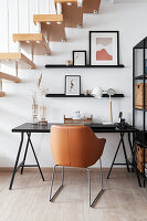 Home office in black, white and brown under the stairs