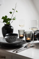 White kitchen table with black and grey tableware