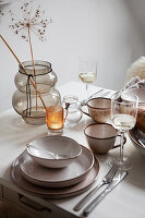 White kitchen table with dishes in beige tones