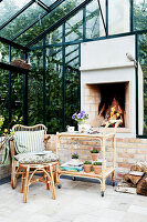 Rattan furniture and an open fireplace in a conservatory