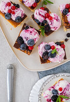 Sponge cake slices with curd mousse, wild berries, and chocolate