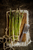 Fresh green asparagus spears on a wooden board