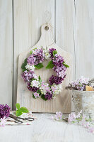 Wreath of lilacs on a wooden board