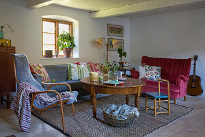 Various seating around antique table in rustic living room