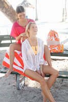 Girlfriends doing their hair on the beach