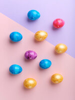 Flat lay with colored easter eggs on bright background