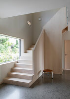 Hallway with terrazzo floor and wooden staircase