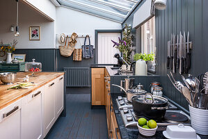 Open kitchen with kitchen island, grey wood panelling on the walls