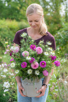 Bouquet of dahlias and Love-in-a-Mist in clay pot