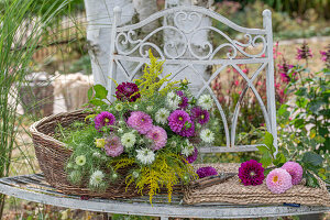 Dahlias, Goldenrod and Maiden in the Green as cut flowers in a wicker basket