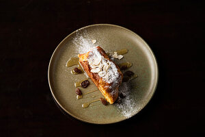 French toast with honey, sultanas and almond flakes