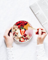Vegan berry smoothie bowl with granola, strawberries and raspberries