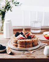 Apple and cinnamon waffles from the oven with fruit and sugar beet syrup