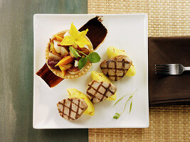 Grilled pork tenderloin slices with wedges of Yukon Gold potatoes and saffron