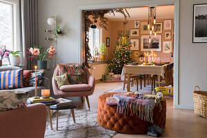 Living room with view into dining room with Christmas tree and festive Scandinavian-style decorations