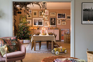 Festive Scandinavian-style dining table with Christmas tree in the background