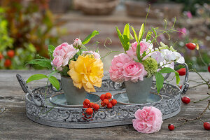 Bouquet of roses (pink), rose hips, rowan berries, purple coneflower 'Milkshake' (Echinacea purpurea), broad-leaved vetchling (Lathyrus latifolius)