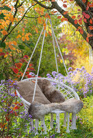 Hanging chair in autumnal garden