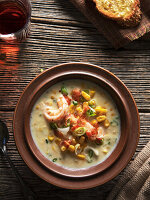 Shrimp soup with bacon crumbles and spring onions