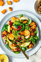 Field salad with halloumi, pumpkin, pomegranate, avocado, and walnuts