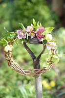 Wreath with Helleborus flowers on a spade handle