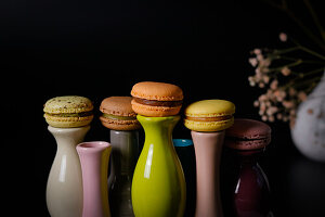 Macarons on colorful ceramic vases