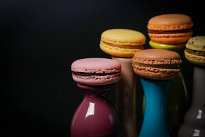 Macarons on colourful ceramic vases