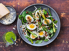 Salad with asparagus, eggs, hazelnuts, parmesan, and herb dressing