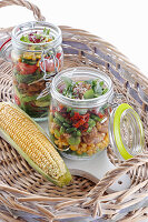 Vegetable salad with meat in jars
