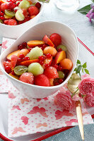 Fruit salad with melon, grapes, peaches and currants