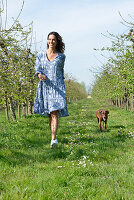 Brunette woman with dog in the garden