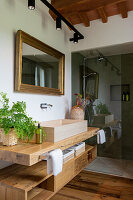 Wooden washbasin and modern glass shower in the bathroom