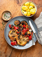 Pork chops with grilled eggplant and tomato ragout