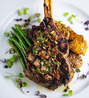 Grilled veal chop, sautéed green beans and smashed potatoes