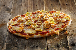 Sourdough pizza with tomato sauce, pancetta, calamaretti and artichokes