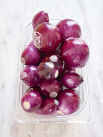 Fresh whole red onions on table