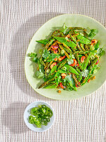 Vegan salad of asparagus, snow peas and cashew nuts