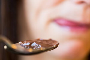 Woman eating chocolate cream