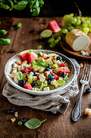 Light salad with cheese, fruit, basil and croutons