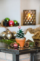 Mini tree made from painted pine cones with wooden star