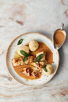 Vegan celeriac roulades with potato dumplings and beer sauce