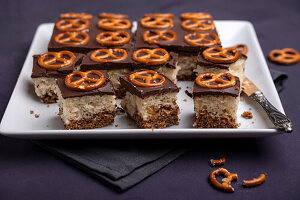 Vegan chocolate and vanilla sponge cake with chocolate icing and salted pretzels