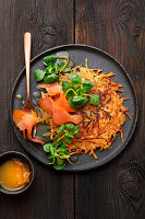 Black salsify rösti with smoked salmon and lamb's lettuce in an orange and mustard dressing