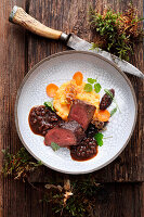 Leg of venison with carrot and potato mash and prunes