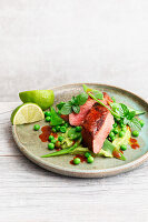 Lamb fillets with pea and mint guacamole and mangetout salad