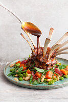 Oven-cooked rack of lamb with ginger marsala jus and sweet potato and bean vegetables